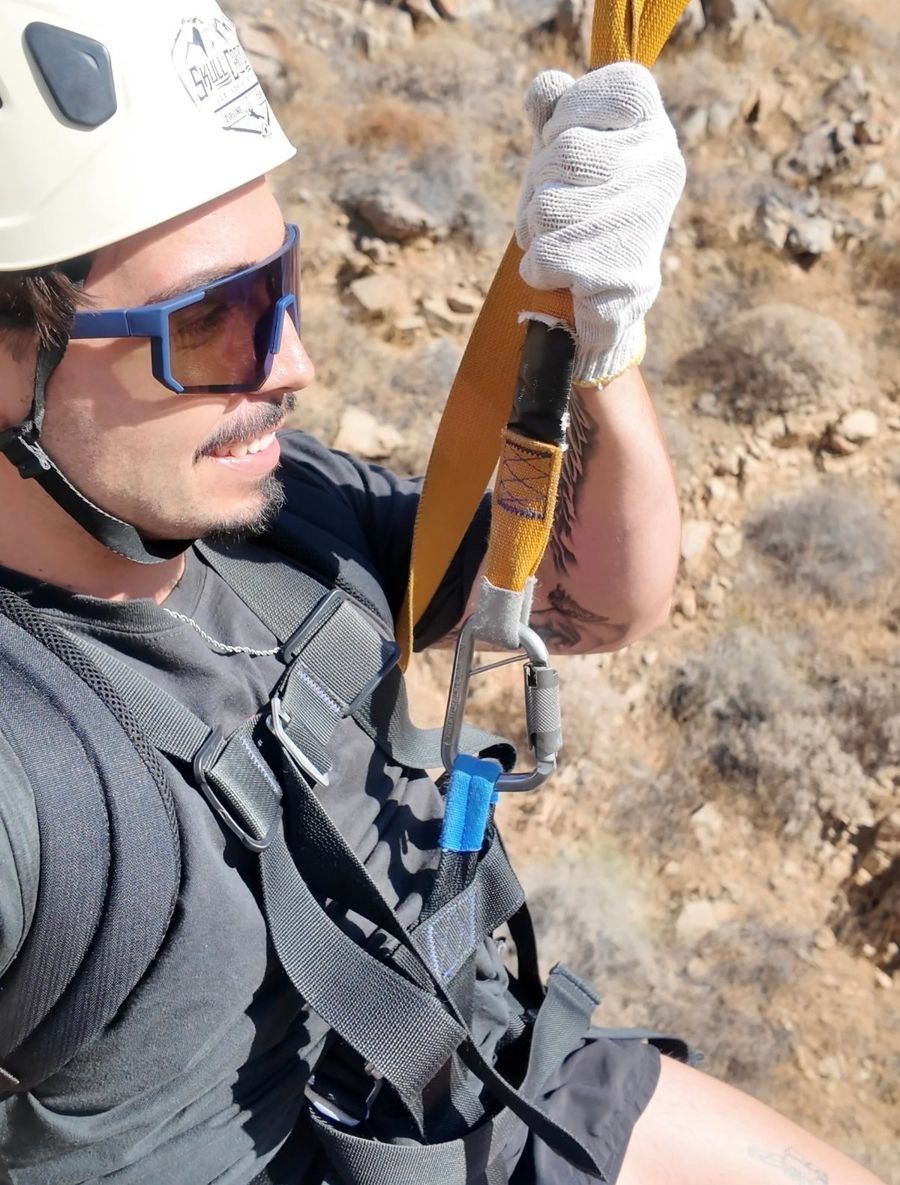 Creator in a Skull Canyon helmet and harness on the zip line course