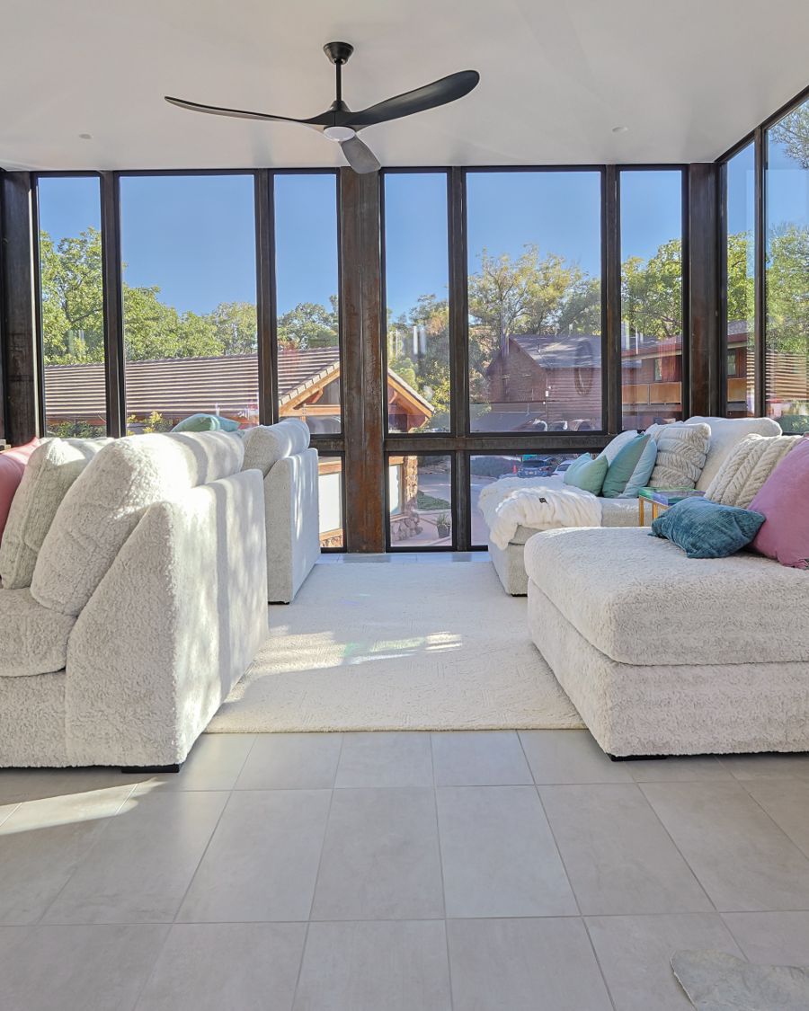 Bright sunroom lounge with sectional seating